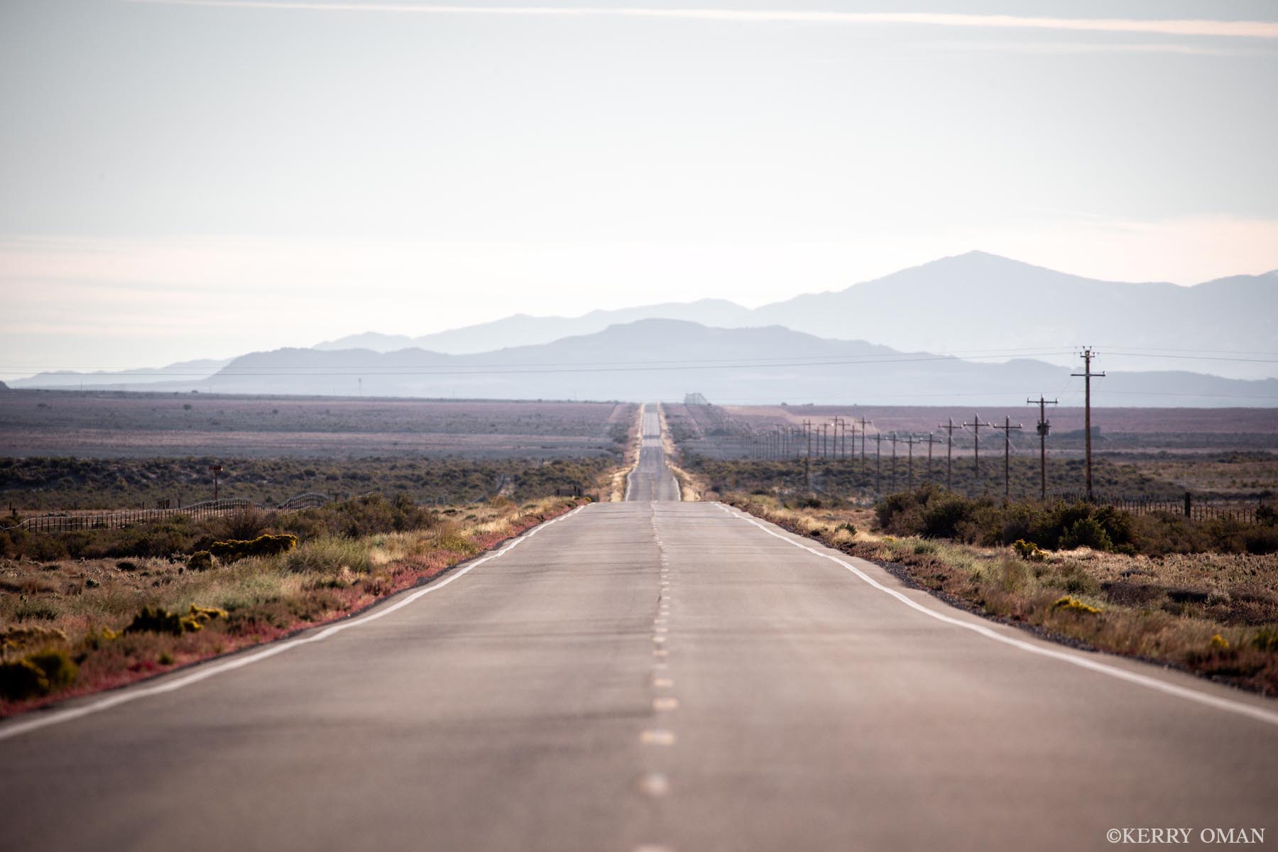 Straight Into the Silence A long stretch of highway cuts across the open desert of the American West, leading the eye toward distant ridgelines softened...